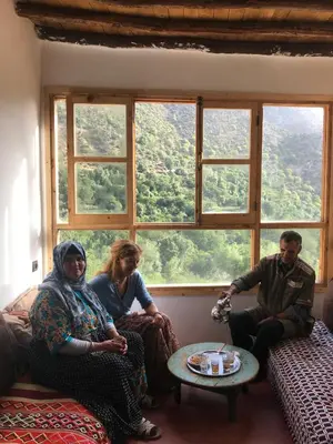 a group of people sitting in a room with a window at Amlougui House in Marrakech
