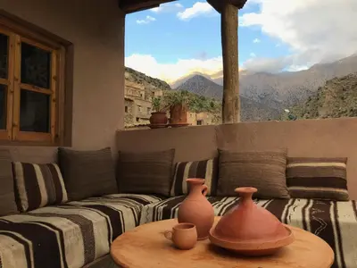 a living room with a couch and a table with vases on it at Amlougui House in Marrakech