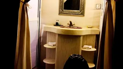 a bathroom with a sink and a mirror at Erg Chebbi Luxury Camp in Merzouga
