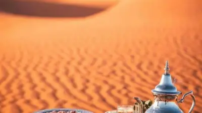 a glass jar on a table in the desert at Erg Chebbi Luxury Camp in Merzouga