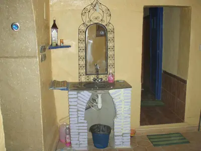 a bathroom with a sink and a mirror at Merzouga Camp and Hostel in Merzouga