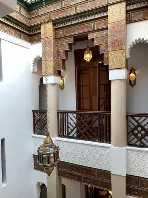 a building with a balcony with a door at Dar Eva in Fès