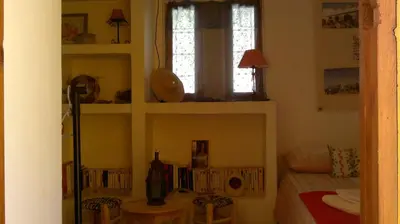 a small room with a bed and a window at Au Bord de l'Eau in Setti Fatma