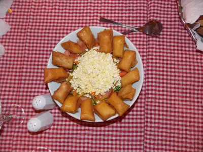 a plate of food on a red and white table at Au Bord de l'Eau in Setti Fatma