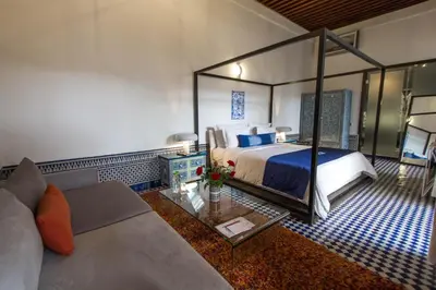 a hotel room with a bed and a couch at Riad Braya in Fès