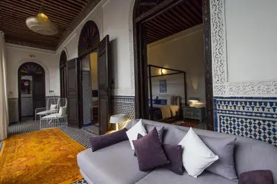 a living room with a couch and a bedroom at Riad Braya in Fès