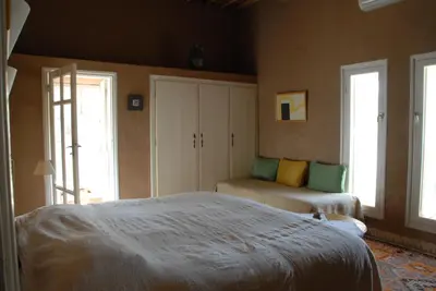 a bedroom with two beds and two windows at Villa Zagora Ma Villa au Sahara in Zagora