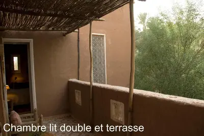 a porch of a house with a balcony at Villa Zagora Ma Villa au Sahara in Zagora