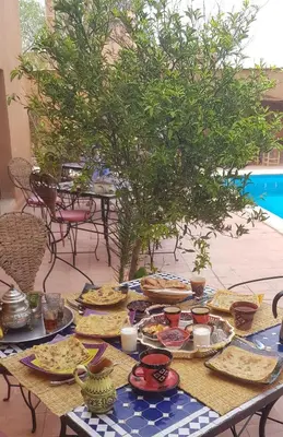 a table with plates of food on top of it at Riad Dar Bergui in Ouarzazate