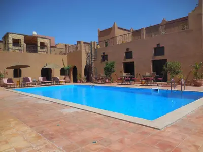 a swimming pool in the middle of a courtyard at Riad Dar Bergui in Ouarzazate