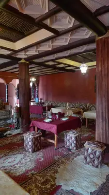 a large room with a table and chairs in it at Maison d'Hôtes Nouflla in Aït Ben Haddou