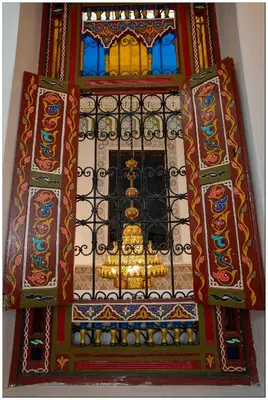a building with a window with a goldituresearchangering at Riad Fés blida in Fès