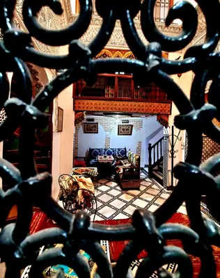 a view of a living room through a wrought iron fence at Riad Fés blida in Fès