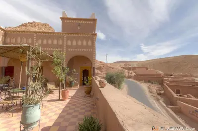 a view of a building in a desert with a road at Kasbah Ounila in Aït Ben Haddou