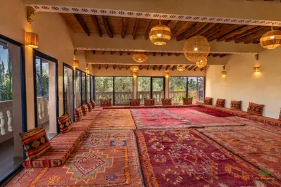 a large room with a large rug on the floor at Ecolodge La Palmeraie in Ouarzazate