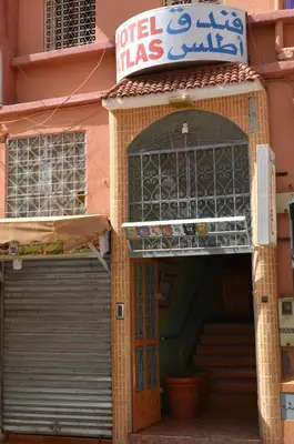 an entrance to a building with a door and a sign at Hotel Atlas Ouarzazate in Ouarzazate