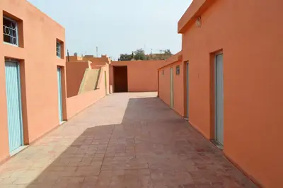 an alley way between two orange buildings with a skate ramp at Hotel Atlas Ouarzazate in Ouarzazate