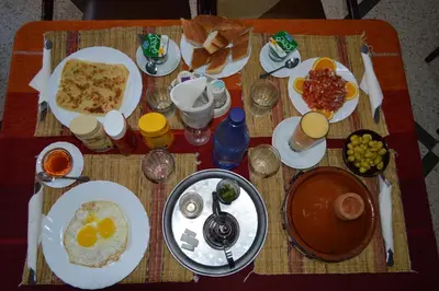 a breakfast table with breakfast foods on it at Hotel Atlas Ouarzazate in Ouarzazate