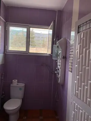 a purple bathroom with a toilet and a window at Villa ain soltan in Imouzzer Kandar