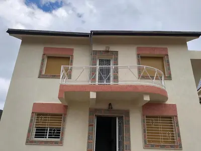 a building with a balcony on top of it at Villa ain soltan in Imouzzer Kandar