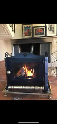 a fireplace with a fire inside of it at Villa ain soltan in Imouzzer Kandar