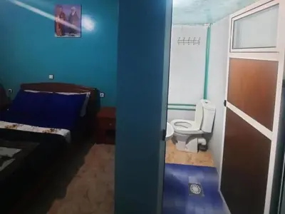 a blue room with a toilet and a bed at Hôtel restaurant Palmiers in Alnif