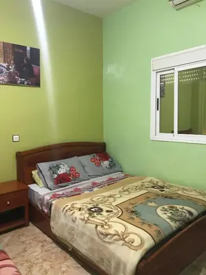 a small bedroom with a bed and a window at Hôtel restaurant Palmiers in Alnif