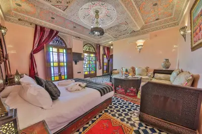 a bedroom with a large bed in a room with a ceiling at Riad Ghita Palace in Fès