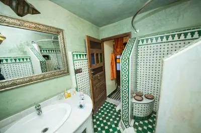 a bathroom with a sink and a mirror and a shower at Riad Ghita Palace in Fès