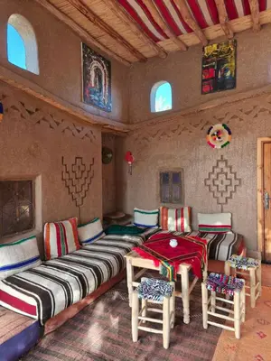 a living room with a couch and chairs in a room at Eco-Ferme Tamalait Skoura in Skoura