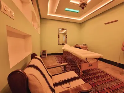 a hospital room with a bed and a mirror at Eco-Ferme Tamalait Skoura in Skoura