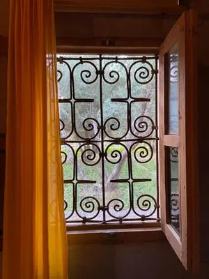 an open window with a curtain next to a window with at Eco-Ferme Tamalait Skoura in Skoura