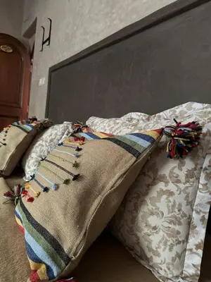 a bed with two pillows and a blanket on it at Ourika Atlas Tigmi in Ourika