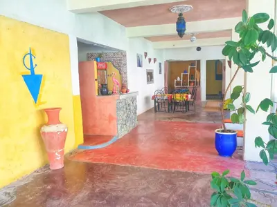 a living room with a vase on the floor at Ourika Atlas Tigmi in Ourika