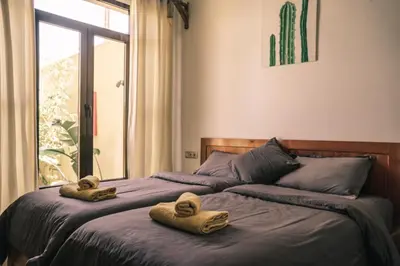 a bedroom with two towels on a bed with a window at The Kozyhome in Ouarzazate