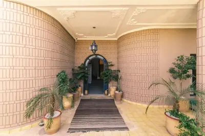 a hallway with tile walls and potted plants at The Kozyhome in Ouarzazate