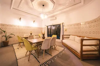 a dining room with a couch and a table and chairs at The Kozyhome in Ouarzazate