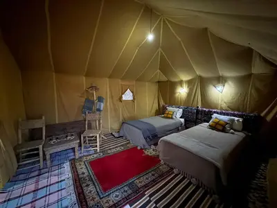 a bedroom with two beds in a tent at Majorelle Desert Camp in Zagora