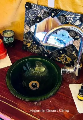 a bathroom sink with a mirror and a green sink at Majorelle Desert Camp in Zagora