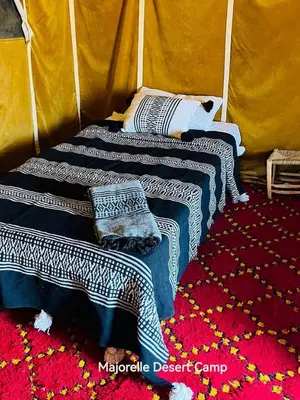 a room with two beds in a tent at Majorelle Desert Camp in Zagora