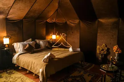 a bedroom with a bed in a tent at Sahara Desert Camping - Merzouga Luxury Camp in Erfoud