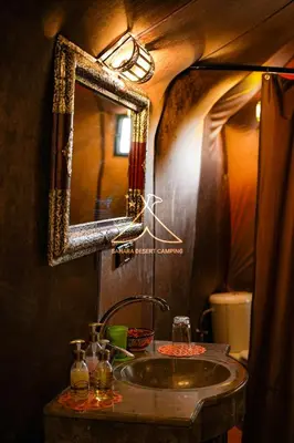 a bathroom with a sink and a mirror at Sahara Desert Camping - Merzouga Luxury Camp in Erfoud