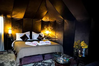 a bedroom with a bed with two towels on it at Sahara Desert Camping - Merzouga Luxury Camp in Erfoud