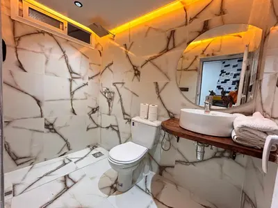 a bathroom with a white toilet and a sink at Salam appartement climatisé hiver et été in Azrou