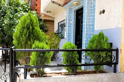 a black gate in front of a house with plants at Salam appartement climatisé hiver et été in Azrou