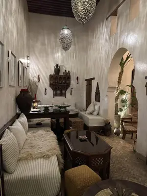 a living room with a couch and a table at Riad Dar Rafti - Restaurant & Rooms with en-suite in Fès