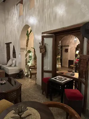 a living room with a couch and a table at Riad Dar Rafti - Restaurant & Rooms with en-suite in Fès