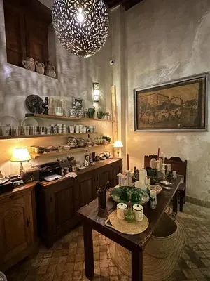 a large kitchen with a table and a chandelier at Riad Dar Rafti - Restaurant & Rooms with en-suite in Fès
