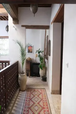 a hallway with two potted plants in a house at Riad Dar Rafti - Restaurant & Rooms with en-suite in Fès