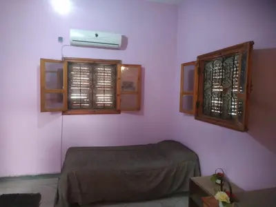 a room with a bed and a window in it at Chez l'habitant (Ba Omar) in Zagora